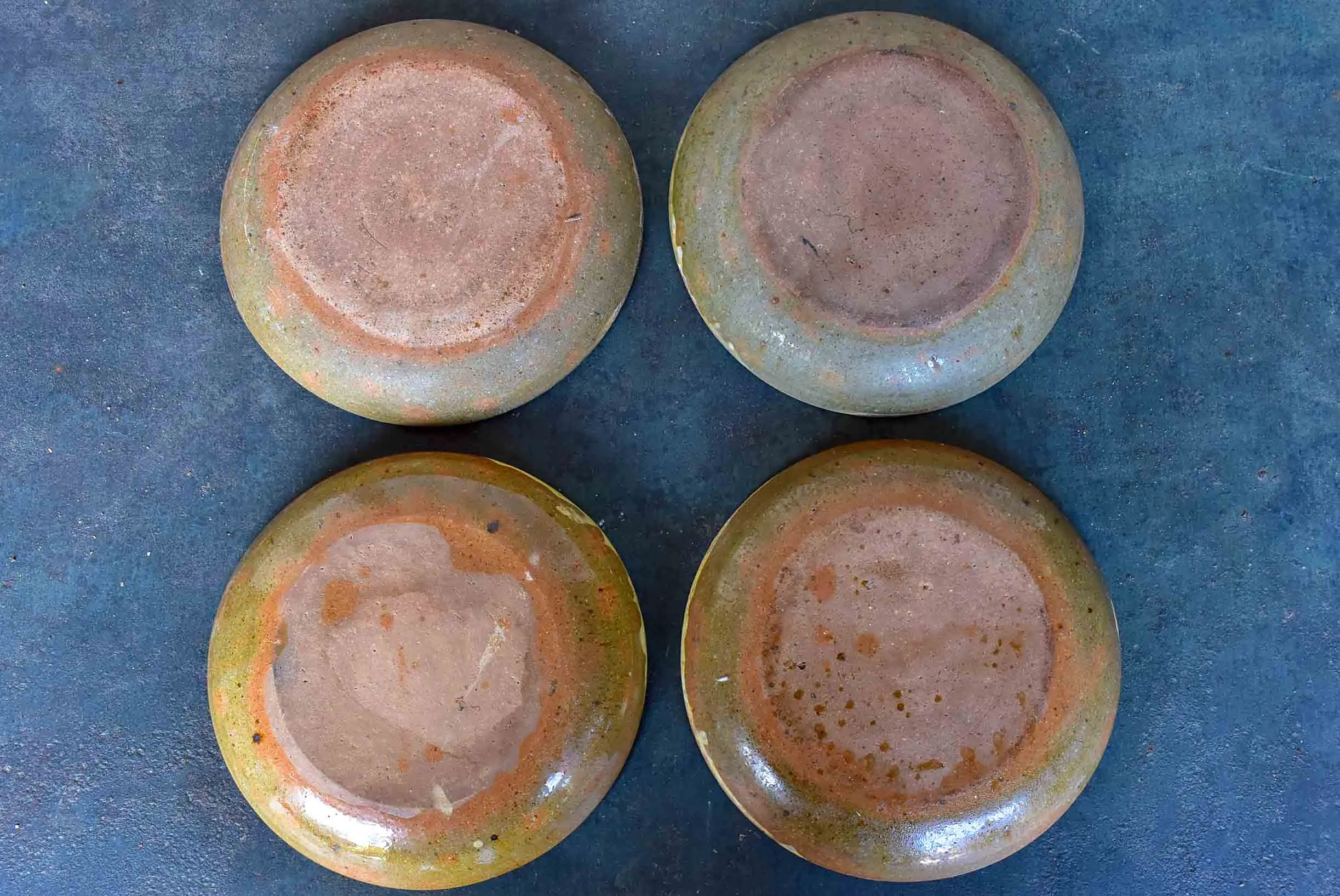 Four rustic French terracotta plates